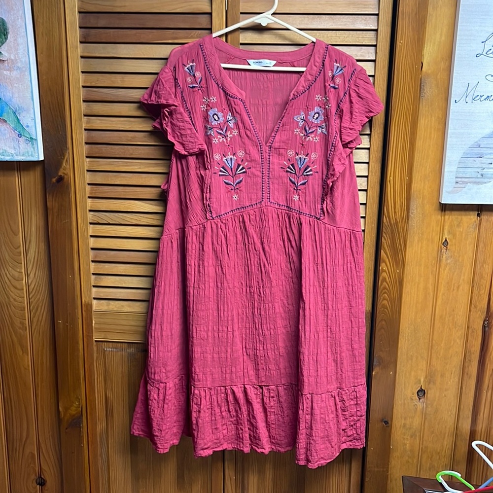 Red dress with blue embroidery.  Small tear in the dress.  Price low